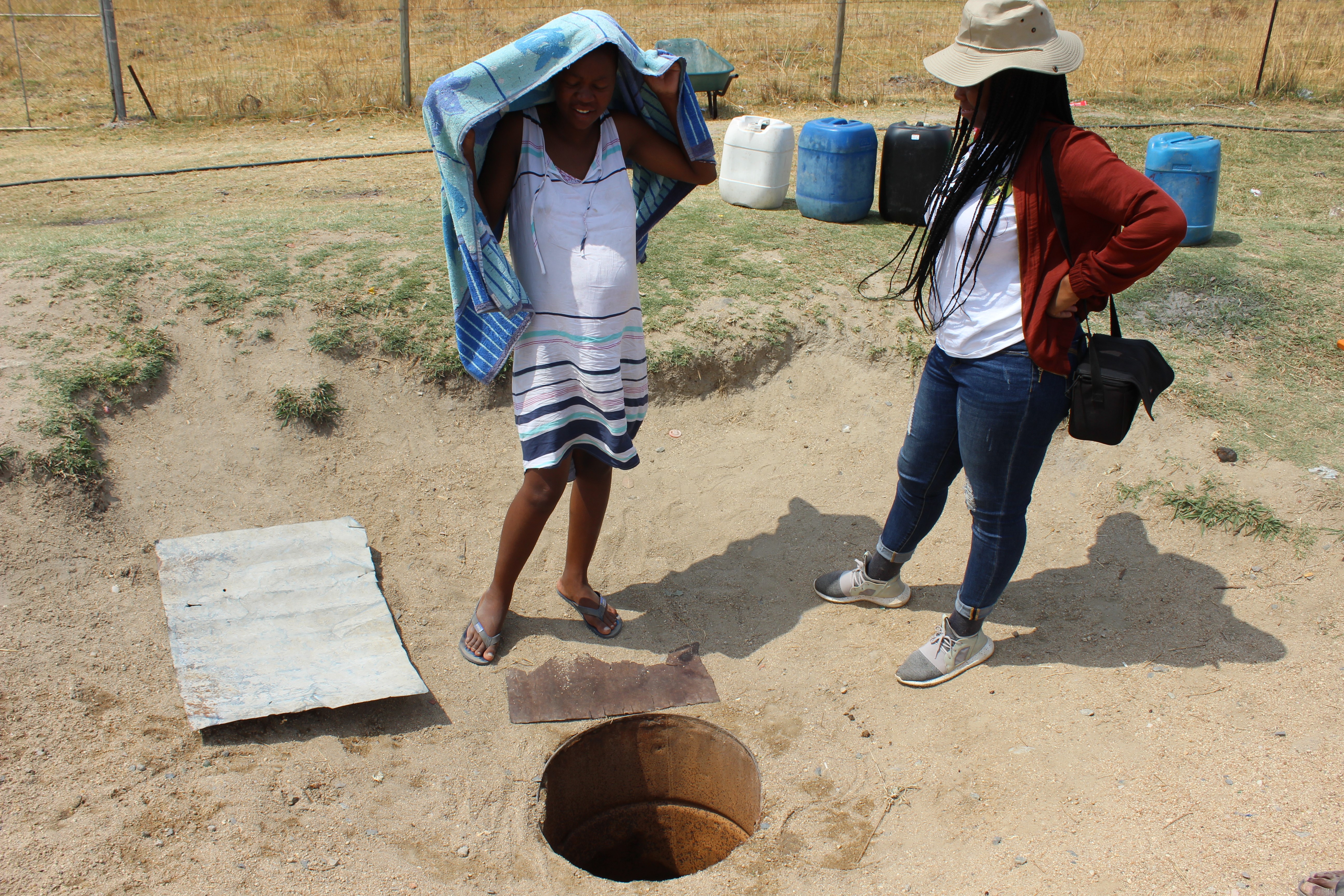 Mrs Lesedi shows AWARD the well that she collects water from on a daily basis (Photo: AWARD)